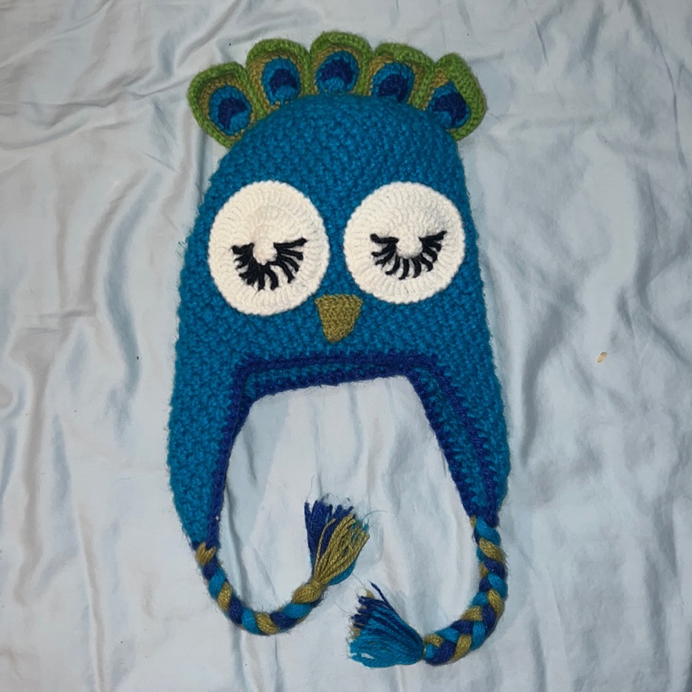 Knitted peacock hat with ear flaps